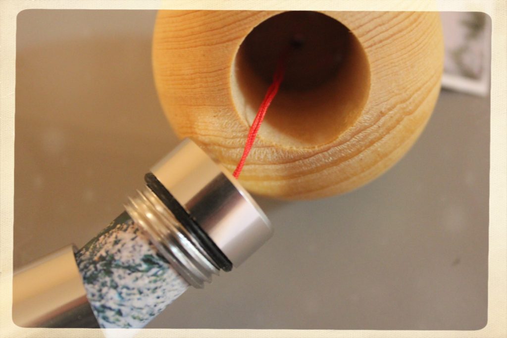 A wooden Christmas ornament opens to show a hidden compartment.